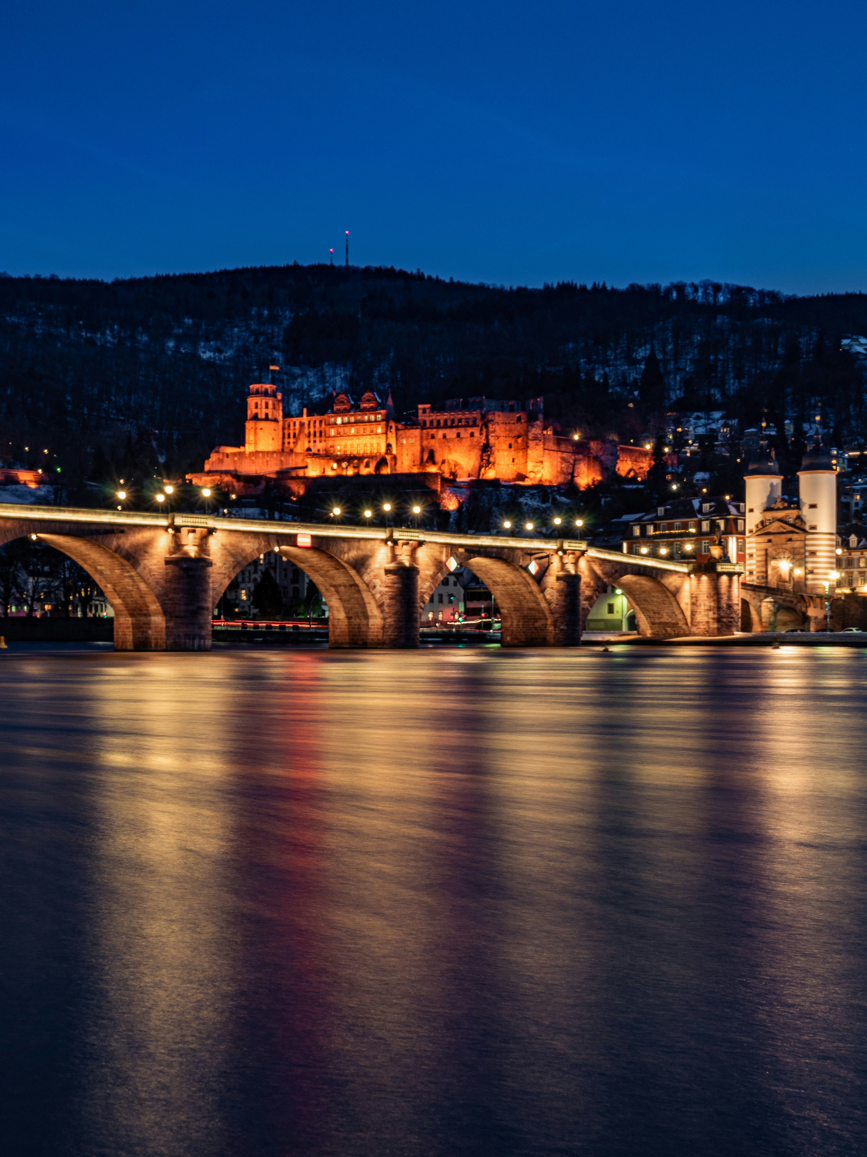 brown concrete bridge over river during night time